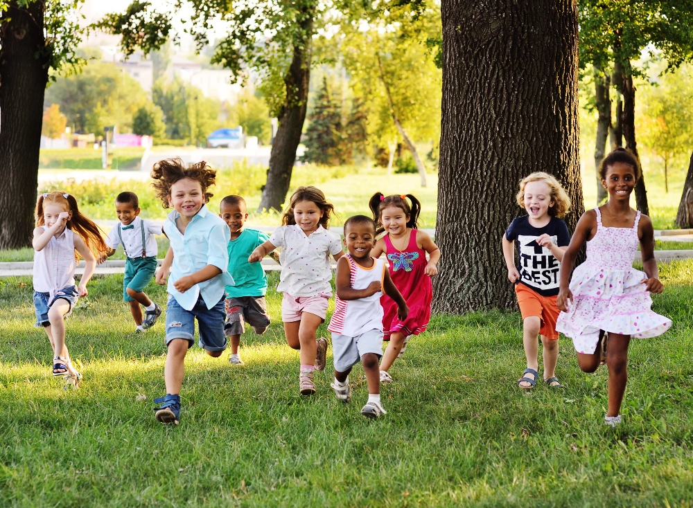 Children running joyfully in a park setting.